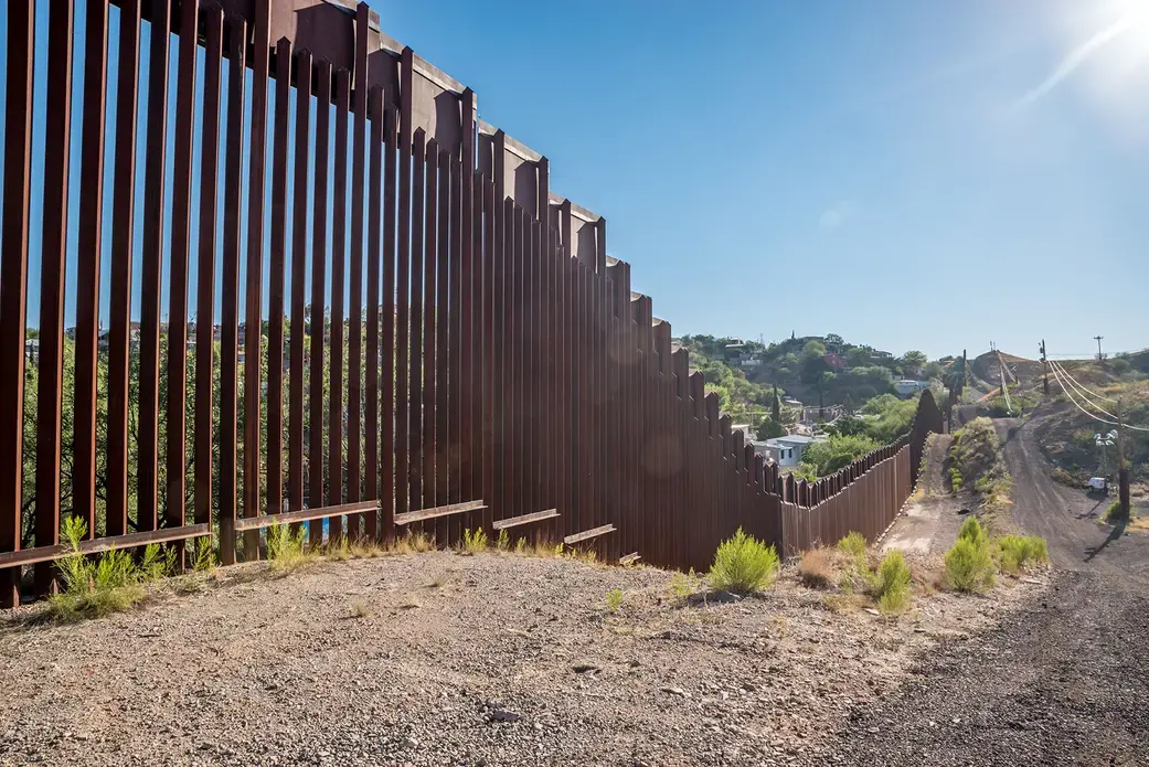 Border fence between United States and Mexico in Nogales, Arizona. Image by Shutterstock. United States, 2017.