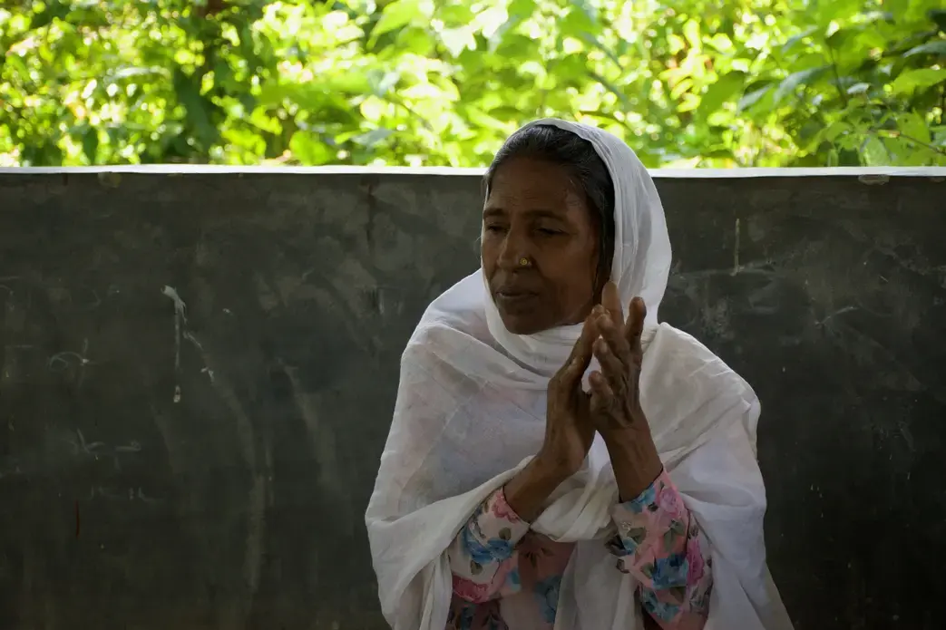 Mustava, 59, sings and plays the harmonium with a band in a Rohingya refugee camp in Bangladesh. “There are people who do not like music, especially when women do it,” she says. “But people like us, we value music because it refreshes our soul.” Image by Sasha Ingber. Bangladesh, 2018. Mustava, 59, sings and plays the harmonium with a band in a Rohingya refugee camp in Bangladesh. “There are people who do not like music, especially when women do it,” she says. “But people like us, we value music because it refreshes our soul.” Image by Sasha Ingber. Bangladesh, 2018.