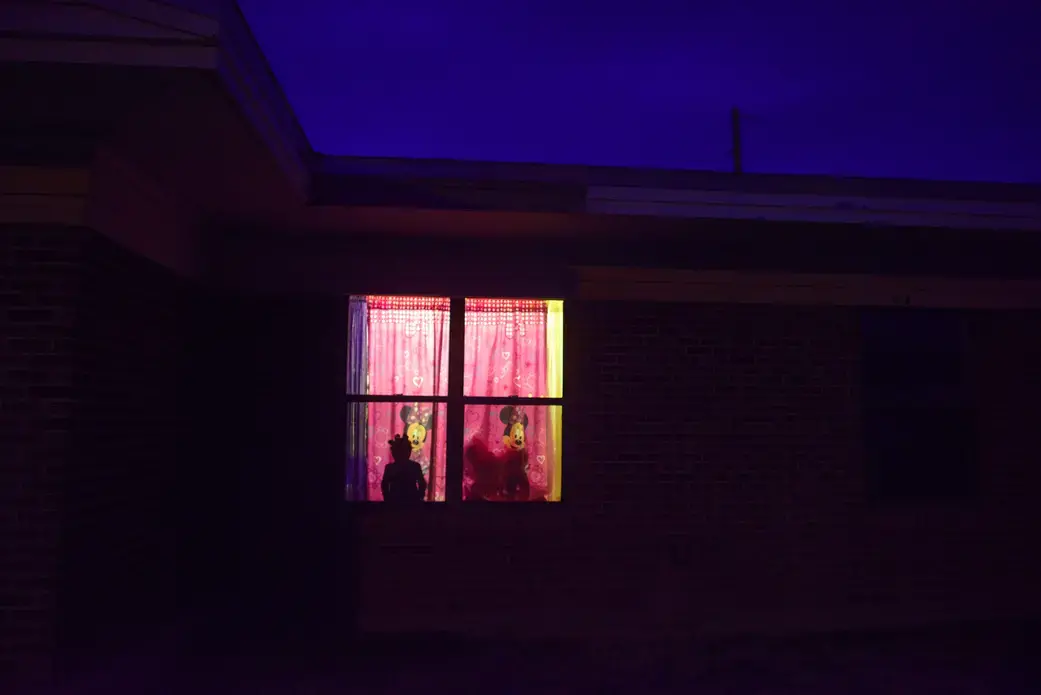 Andrea, age 5, looks out her window in Southern New Mexico. Image by Isadora Kosofsky. Media file: girlhood.jpg