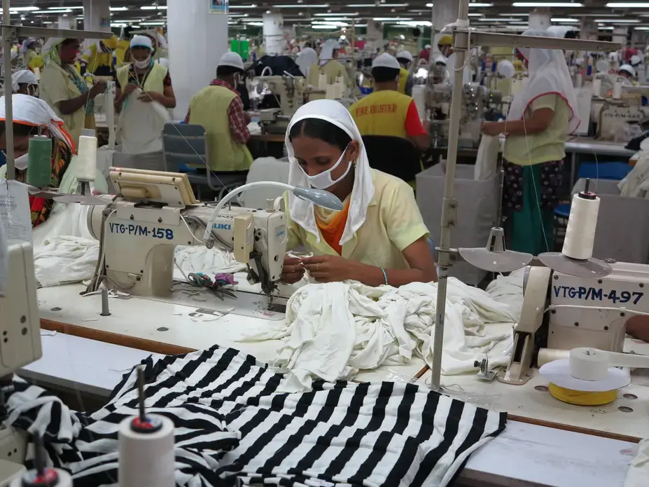 A worker sits at her sewing machine. Bangladesh is second only to China in the global fashion business. Image by Fred de Sam Lazaro. Bangladesh, 2013. Media file: img_0737.jpg