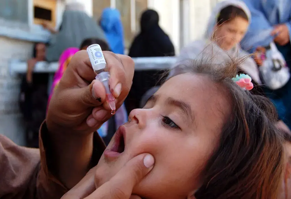 Health worker administrates polio-vaccine drops to a child during anti-polio immunization campaign at Pak-Afghan Border on April 08, 2015 in Chaman. Image by Shutterstock. Pakistan, 2015. Health worker administrates polio-vaccine drops to a child during anti-polio immunization campaign at Pak-Afghan Border on April 08, 2015 in Chaman. Image by Shutterstock. Pakistan, 2015.