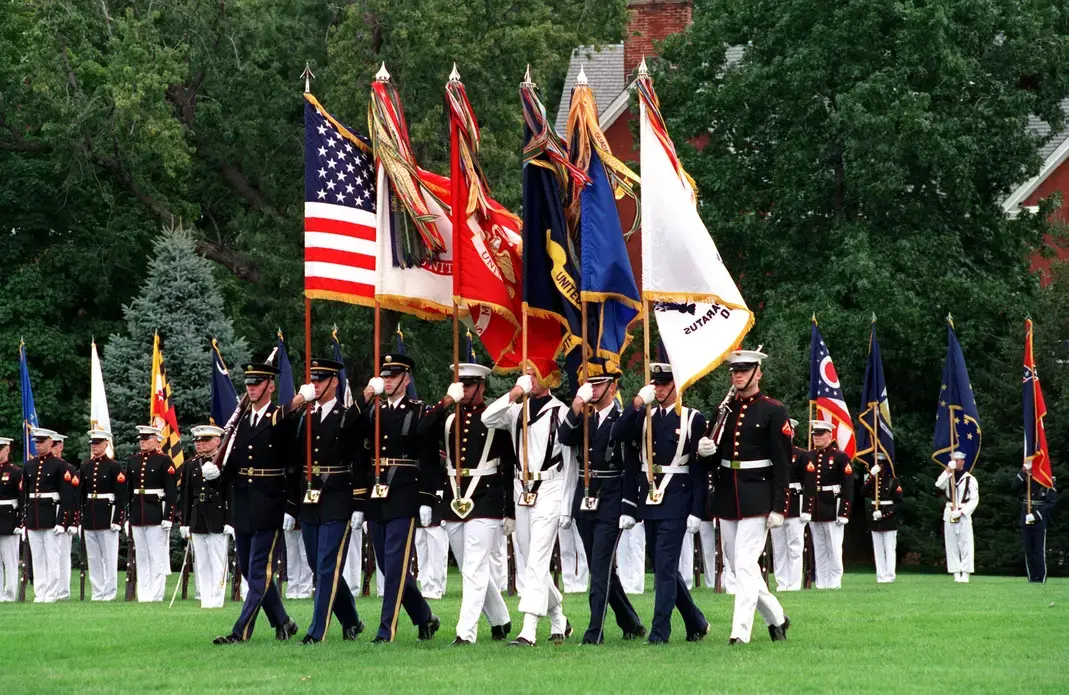Joint Service Color Guard advances the colors during the retirement ceremony of Chairman of the Joint Chiefs of Staff Gen. Henry H. Shelton, at Fort Myer, Va., on Oct. 2, 2001, a month after 9/11. Services represented are, from left to right: Army, Marines, Navy, Air Force, Coast Guard, Marines. Image by Helene C. Stikkel/Courtesy of Department of Defense Website. United States, 2001. Media file: us_army.jpg