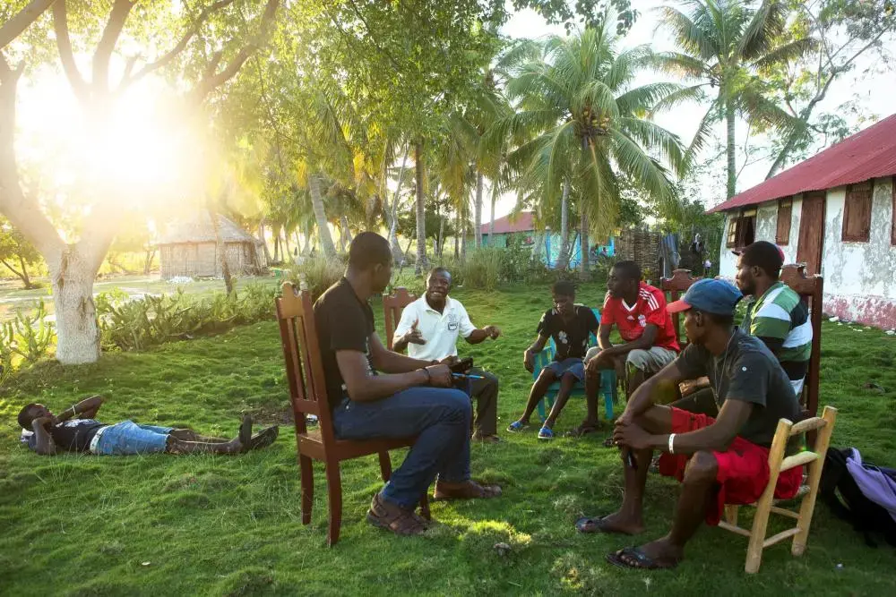Members of KOPI, a grassroots organization made up of four local groups to press the Haitian government for transparency and community participation in its development plans for the island of Ile-a-Vache, Haiti, meet together on the island. Image by Allison Shelley. Haiti, 2014. Media file: allison2.jpg