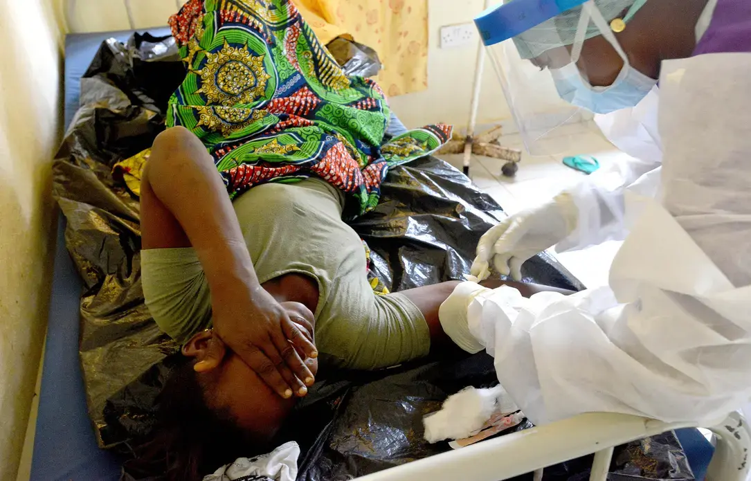 KONO DISTRICT - SIERRA LEONE Aminata Kamara, 25, is prepped for a blood transfusion during treatment for uncontrolled bleeding at Kono Government Hospital in Sierra Leone's rural Kono District on March 30, 2015. Two days earlier Kamara underwent surgery to have her dead fetus removed. Image by Michael G. Seamans. Sierra Leone, 2015. Media file: healthcare_sierra_leone_009.jpg