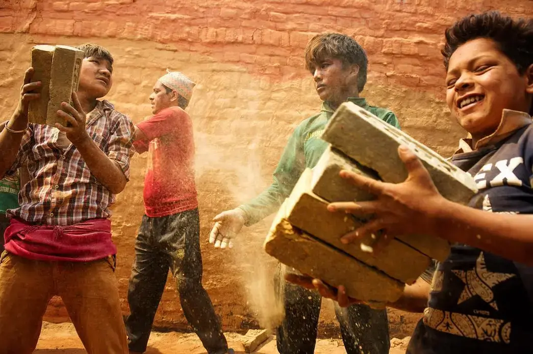 Young boys help stack bricks inside a kiln in Dhading district, Nepal. Despite a national law that bans children under the age of 14 from working, such scenes are commonplace in the country’s brick making industry. Image and caption by Ann Hermes. Nepal, 2016. Media file: tumblr_o5nug9autw1rf8lnho1_1280.jpg
