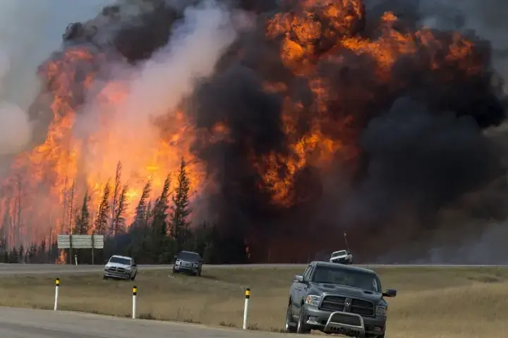 A wildfire burns near Fort McMurray, Alberta, Canada, on May 7. Image courtesy of Premier of Alberta/flickr. A wildfire burns near Fort McMurray, Alberta, Canada, on May 7. Image courtesy of Premier of Alberta/flickr.