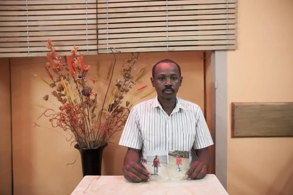 Maurice Pierre Herynirina holds a photograph of his wife, Solange Razafindrasoa, in an Antananarivo cafe last December. He learned in February that she had died in Saudi Arabia, where she was working as a domestic servant. Image by Rijasolo / Riva Press. Madagascar, 2013. Media file: hery.jpg