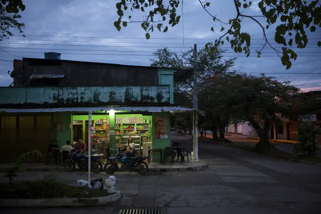 Men enjoy an evening snack at a small shop in Vista Hermosa, Meta, Colombia on Thursday, March 8, 2018. Image by Greg Kendall-Ball. Colombia, 2018. Men enjoy an evening snack at a small shop in Vista Hermosa, Meta, Colombia on Thursday, March 8, 2018. Image by Greg Kendall-Ball. Colombia, 2018.