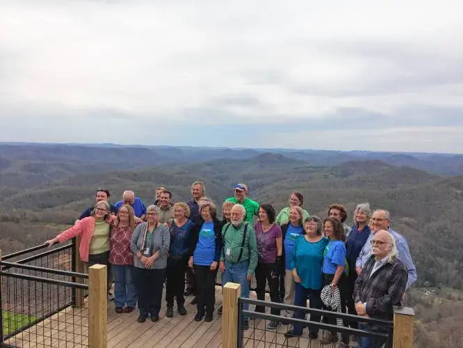 Residents of Leverett and Letcher County, Kentucky pose for a photo together at Hogg Mountain at the end of their four-day visit together. Image by Richie Davis. United States, 2018. Residents of Leverett and Letcher County, Kentucky pose for a photo together at Hogg Mountain at the end of their four-day visit together. Image by Richie Davis. United States, 2018.