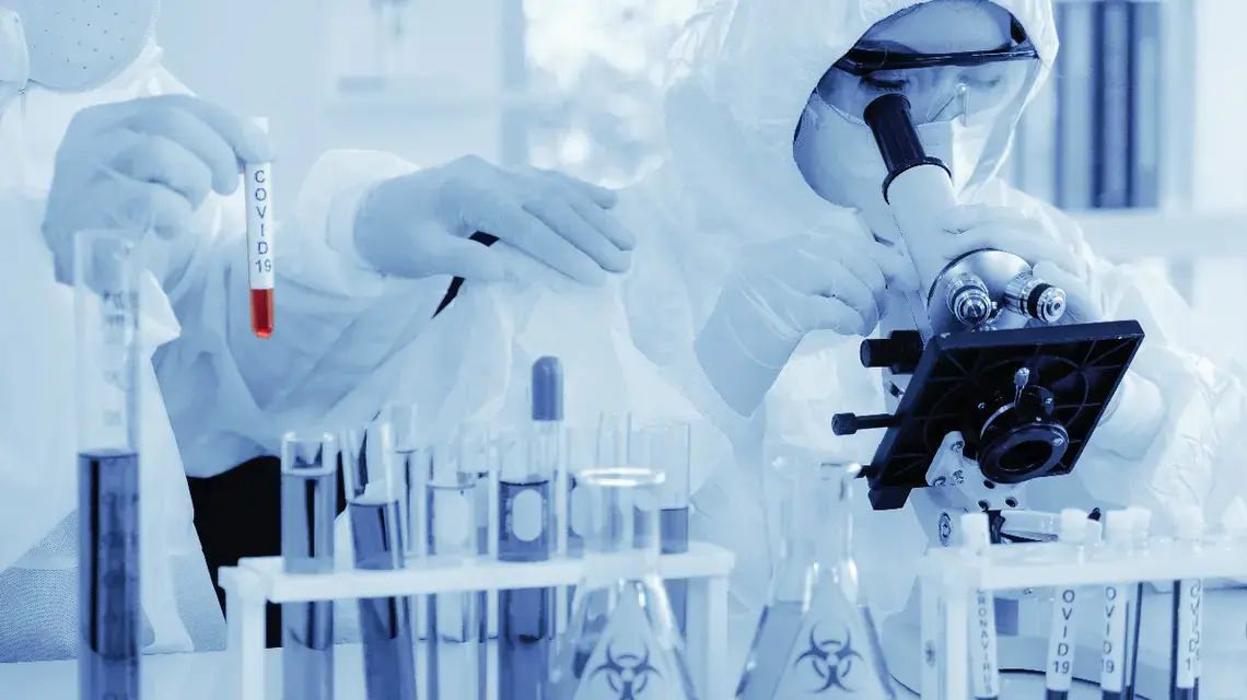 Scientists analyze COVID-19 samples. Image via Shutterstock. Scientists analyze COVID-19 samples. Image via Shutterstock.