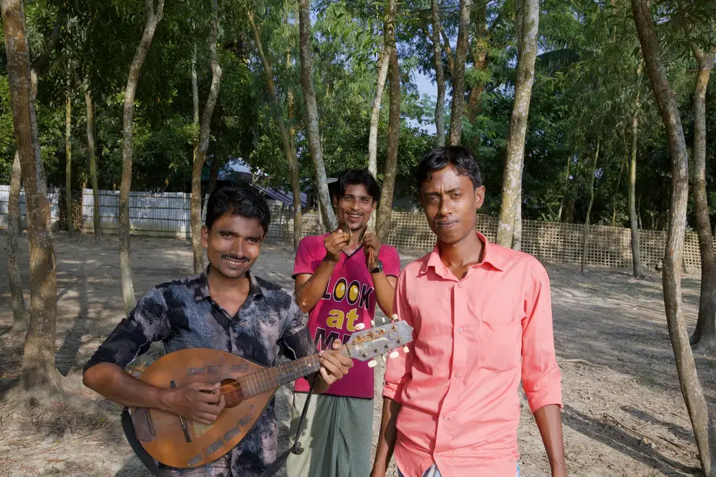 (Left to right) Siraz Ulislam, Amanullah, and Azimullah perform at social gatherings, for humanitarian organizations, and when people commission them to make songs about their lives. Image by Faiham Ebna Sharif. Bangladesh, 2019.