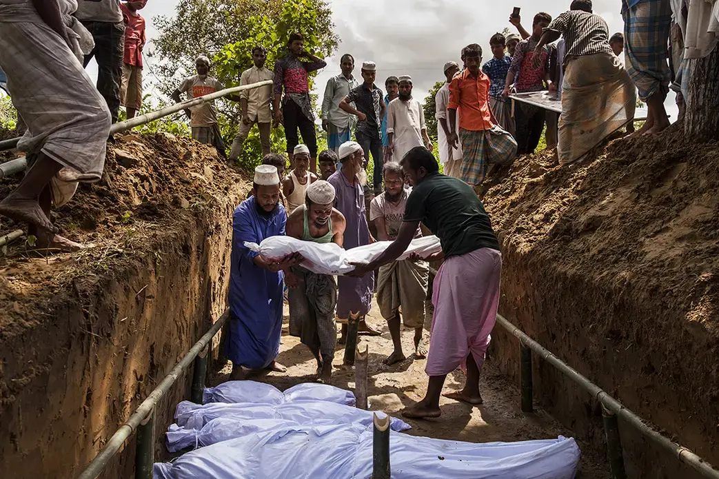 Bengali residents from the nearby Inani village donated the land and dug the mass grave for the 15 bodies recovered near their Inani Beach. Of the more than 100 Rohingyas from a boat that had capsized in the Bay of Bengal, only 17 people survived. Image by Patrick Brown/Panos Pictures/UNICEF. Bangladesh, 2017.