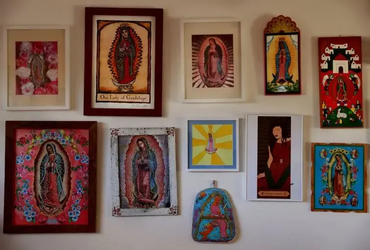 Claudia Castro Luna collects images of the Virgin of Guadalupe, which are displayed in her Seattle home. Her book “Killing Marías” is comprised of 44 poems, each honoring a woman who was killed in Ciudad Juárez. The book was written with the Virgin of Guadalupe in mind. “In order for the book to do what I wanted to do, which was to give dignity, and honor the women … it was important to dwell in the realm of spirit and beauty,” she says. “A constant return to natural spaces of beauty and love.” Image by…