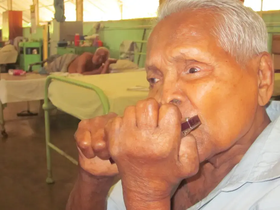 Gunathilike was sent to the Hendala Leprosy Hospital in 1946. He plays the mouth organ in the hospital band. Image by Ross Velton. Sri Lanka, 2015. Gunathilike was sent to the Hendala Leprosy Hospital in 1946. He plays the mouth organ in the hospital band. Image by Ross Velton. Sri Lanka, 2015.