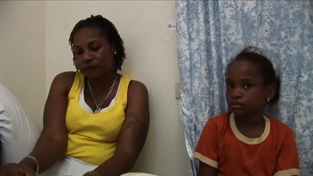 Simone and her daughter Khayla in hiding at a safe house outside of Kingston, Jamaica. Image by Micah Fink. Jamaica, 2009. Media file: simone_pic.jpg