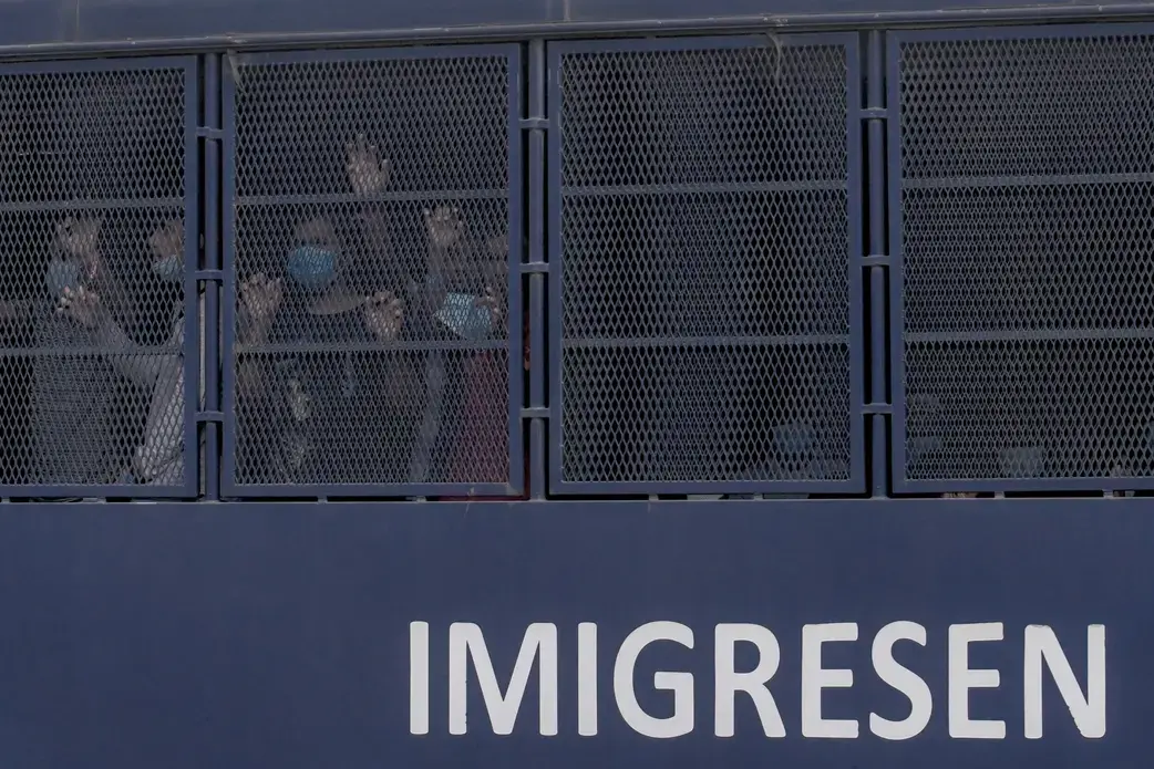 Authorities round up people during an immigration raid in Selayang, north of Kuala Lumpur, on May 11. More than 1,300 people were arrested in the raid, which followed a coronavirus lockdown. Image by Hasnoor Hussain / The New Humanitarian. Malaysia, 2020.