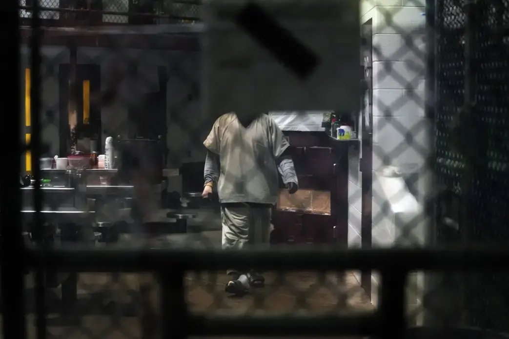 A prisoner at Guantánamo Bay. Lawyers are seeking to contact their clients there while the pandemic keeps them from traveling to the base. Image by Doug Mills / The New York Times. United States, undated.