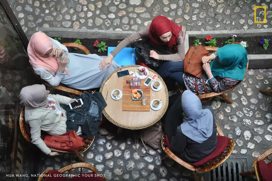 After the war, life recovered thanks to the strong will of people. The independence of women is one of the main ingredients of the strong will. Pictured here is Bosnian women enjoying their lives in a bar of Sarajevo. Image by Hua Wang. Bosnia.
