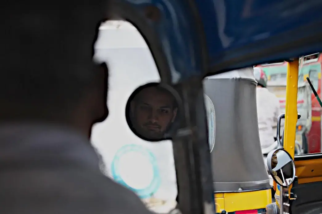 Priyank Mathur, creator of the "Fight Terror With Comedy" programs rides in a rickshaw through Mumbai. Image by Wes Bruer. India, 2017. Priyank Mathur, creator of the "Fight Terror With Comedy" programs rides in a rickshaw through Mumbai. Image by Wes Bruer. India, 2017.