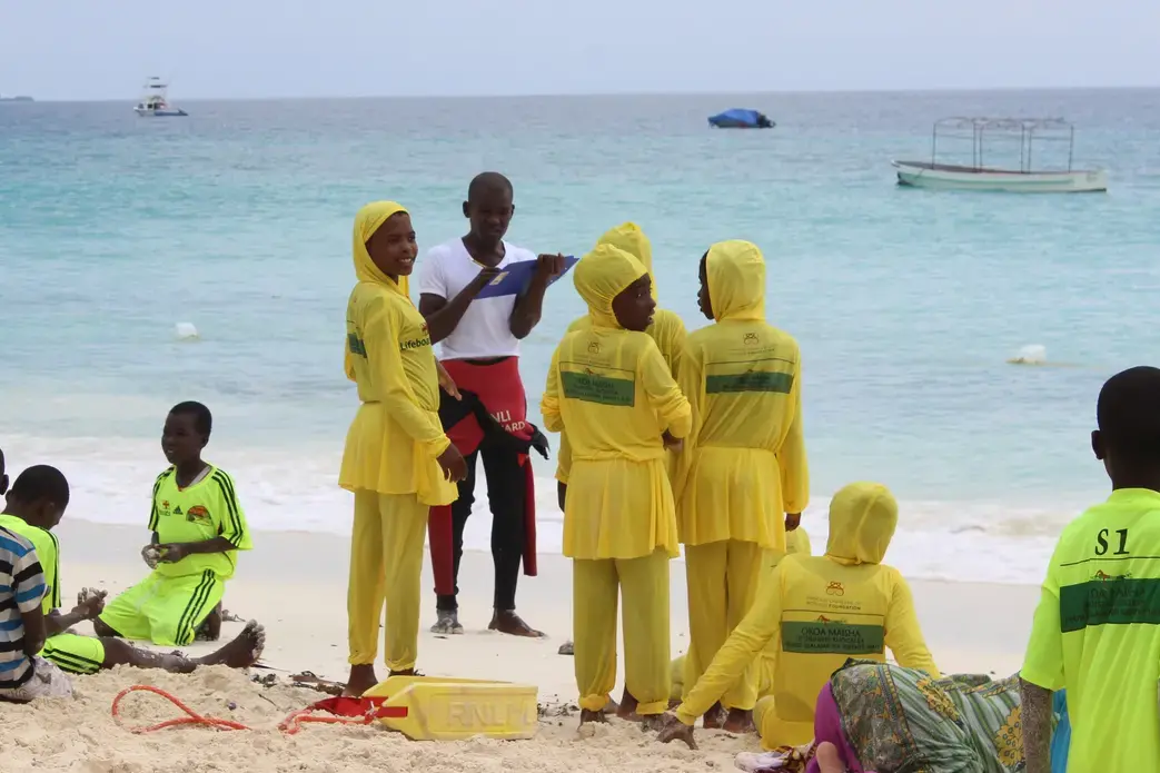 Girls from Nungwi Secondary School await instructions from Master Trainer Haji Ali Haji on their first day of swim lessons. Image by Claire Felter. Tanzania, 2015. Media file: img_0387.jpg