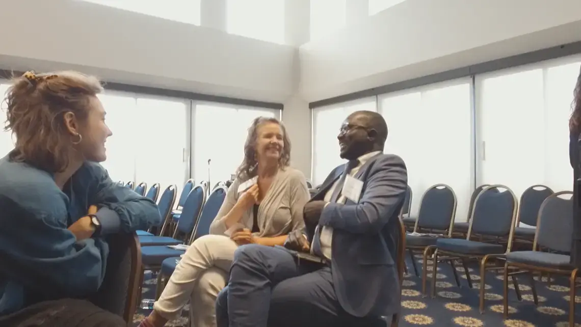 Teaching Partners Alexandra and Laura Marie discuss the panel with conference participant. Image by Dominique Green. Washington, D.C., 2019.