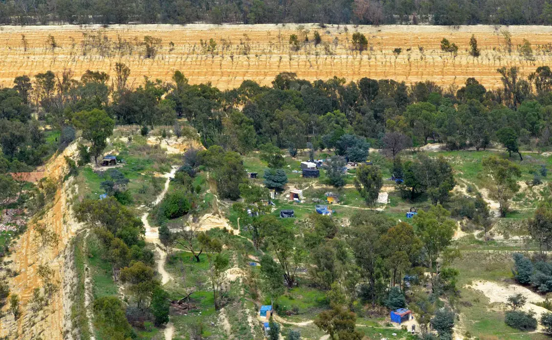 informal settlement An informal settlement near Johannesburg sits atop a pile of unrehabilitated gold mine waste. Image by Mark Olalde. South Africa, 2017.