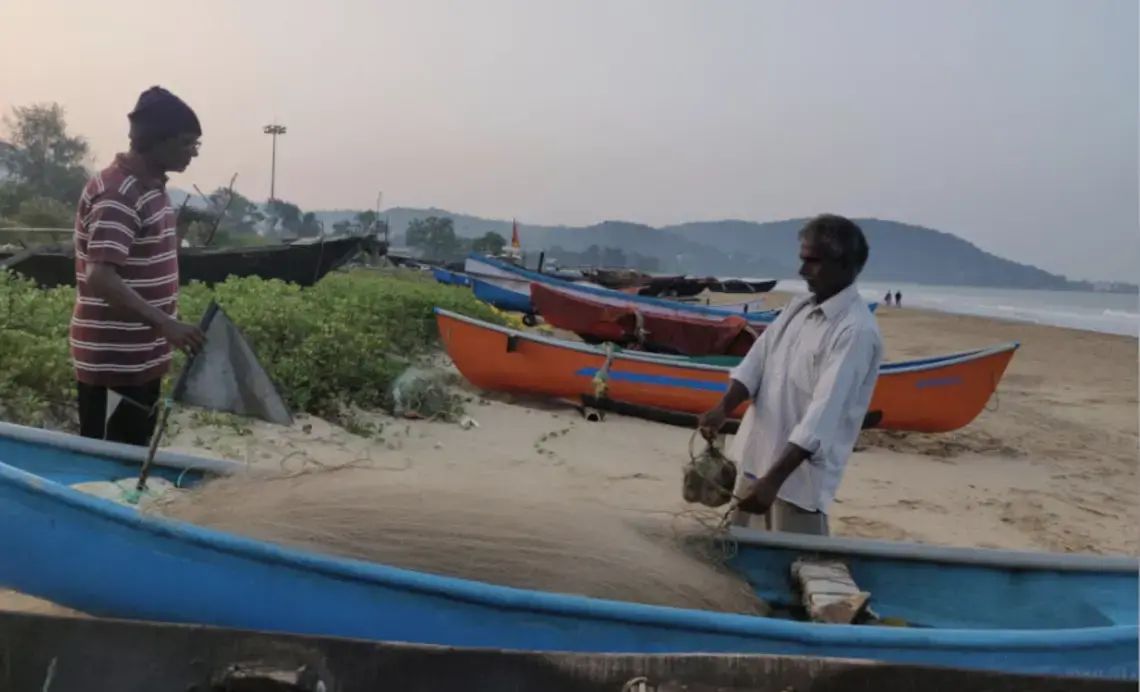 Sadanand Malshekar (right), 62, is among the thousands of fisherfolk who are worried that the Karwar port’s expansion will pollute the water in the fishing harbour and damage the beach they use to anchor their boats. Image by Disha Shetty / IndiaSpend. India, 2020. Sadanand Malshekar (right), 62, is among the thousands of fisherfolk who are worried that the Karwar port’s expansion will pollute the water in the fishing harbour and damage the beach they use to anchor their boats. Image by Disha Shetty / IndiaSpend. India, 2020.
