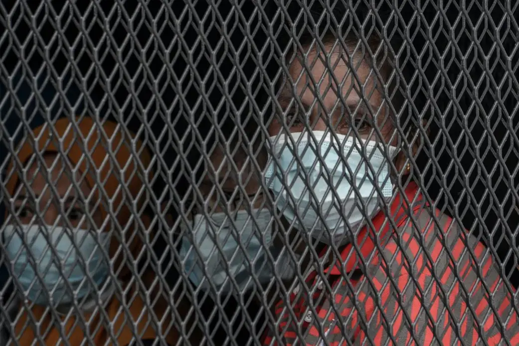 A woman looks out from an immigration truck transporting her to detention following a raid in Petaling Jaya, Kuala Lumpur on May 20. Image by Hasnoor Hussain. Malaysia, 2020.