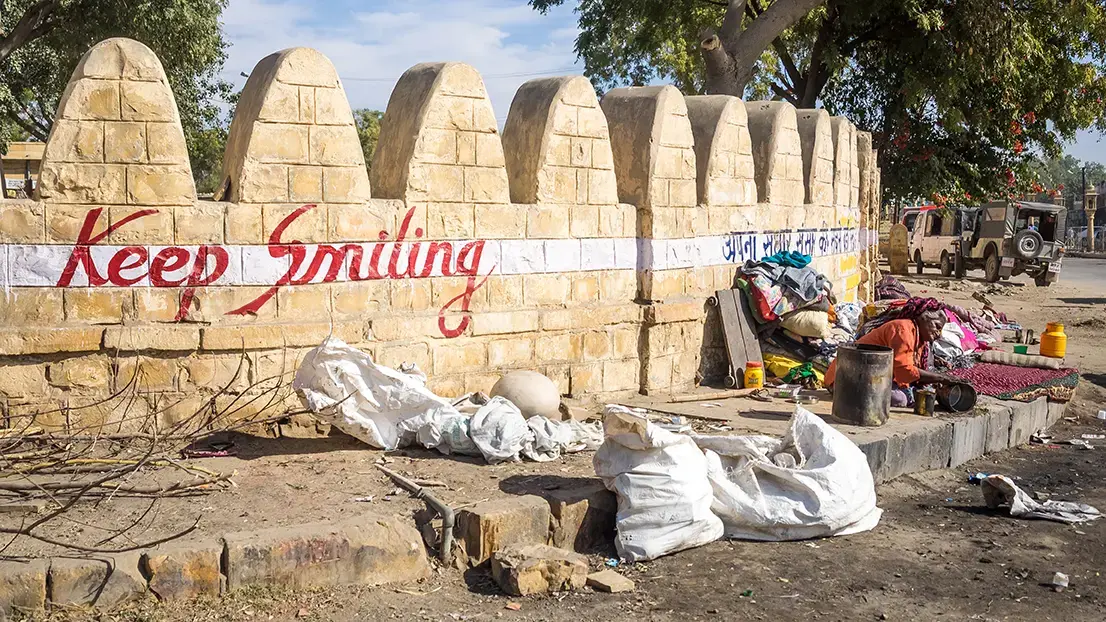 "Keep Smiling" is emblazoned on a wall in Jaisalmer. Image by Micha Weber / Shutterstock.com. India, 2016. "Keep Smiling" is emblazoned on a wall in Jaisalmer. Image by Micha Weber / Shutterstock.com. India, 2016.
