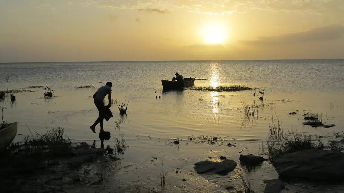 The proposed canal would cross the lake several miles south of where this boy balances on a rock at the edge of the eastern shore of Lake Nicaragua. Image by Tim Johnson/McClatchy. Nicaragua, 2015. Media file: nicacanal-secrecy_03.jpg
