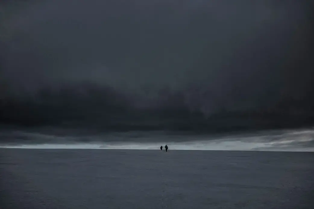 Glaciologists climb the Bellingshausen Dome to measure the depth and consistency of this 500-foot-deep cap of ancient ice in Antarctica. Image by James Whitlow Delano. Antarctica, undated. Glaciologists climb the Bellingshausen Dome to measure the depth and consistency of this 500-foot-deep cap of ancient ice in Antarctica. Image by James Whitlow Delano. Antarctica, undated.