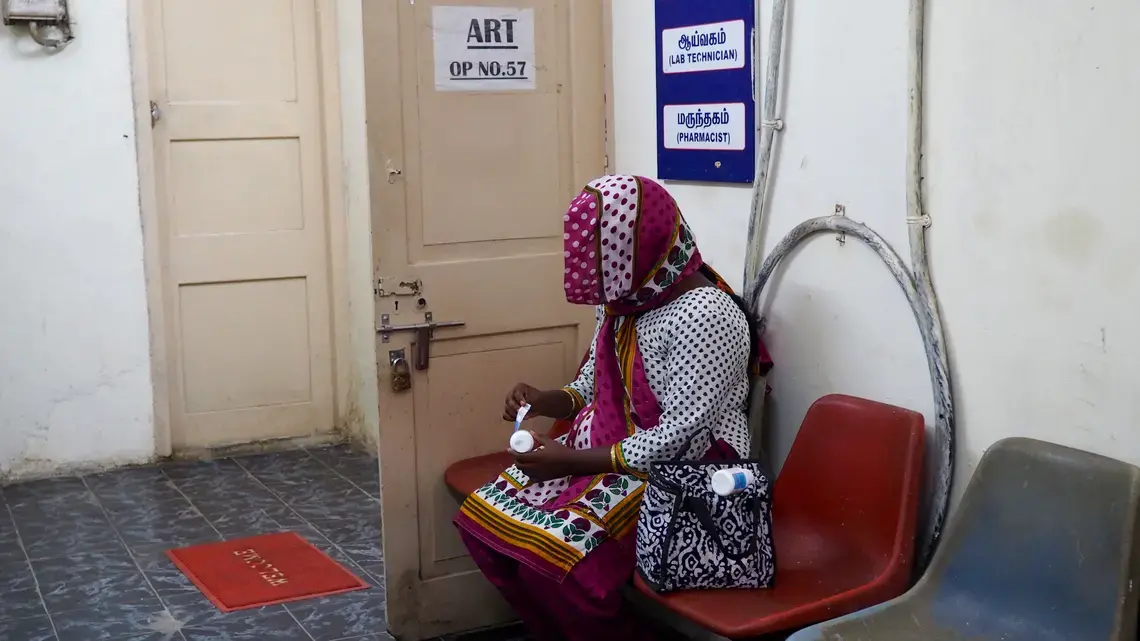An HIV-positive woman the peels the labels off her medication at the government ART center so that her family members will not discover her HIV status. Image by Adita Kantipuly. India, 2016 Media file: katipuly-india_health_center.jpg