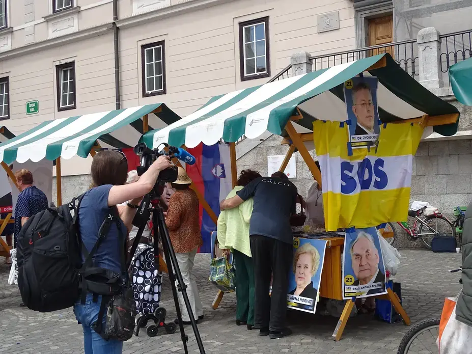 The media focuses its attention on the Slovenian Democratic Party (SDS) as they campaign in the city center. SDS won the election with a 24.4 percent majority vote. Image by Olivia Watson. Slovenia, 2018.