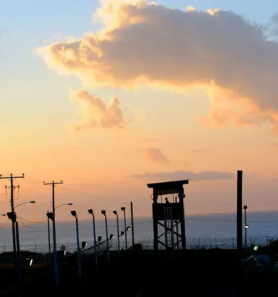 A watchtower at the Guantanamo Bay prison camp, at dusk. Image courtesy of Wikimedia Commons. Cuba, 2011. A watchtower at the Guantanamo Bay prison camp, at dusk. Image courtesy of Wikimedia Commons. Cuba, 2011.