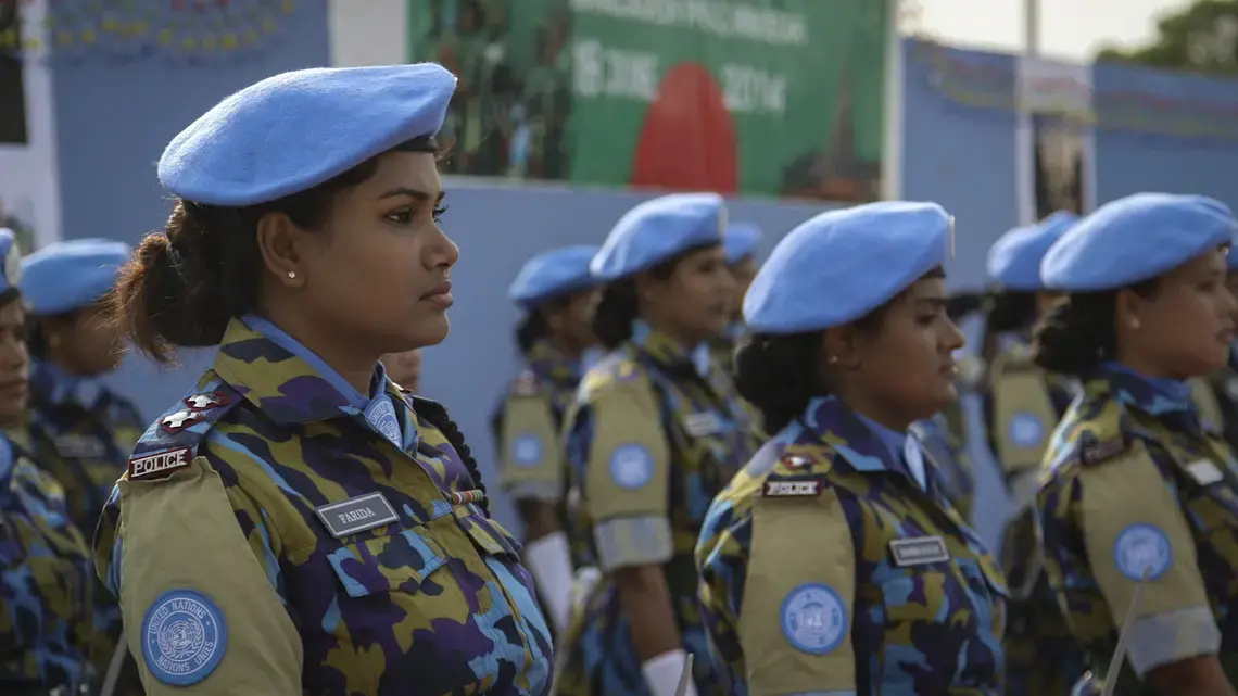 Farida Parveen, a foot soldier from Bangladesh, stands in line.