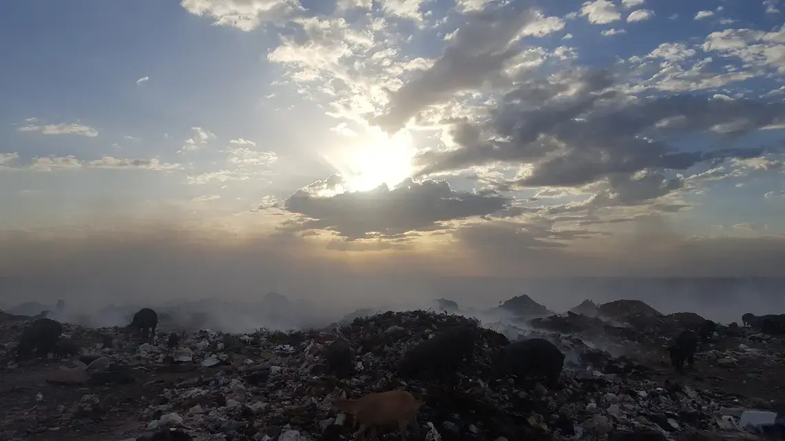The garbage dump at Truitter, outside Port-au-Prince, burns day and night. After the 2010 earthquake in Haiti, raw sewage was also dumped there until a new site was built. Image by Rebecca Hersher. Haiti, 2017. The garbage dump at Truitter, outside Port-au-Prince, burns day and night. After the 2010 earthquake in Haiti, raw sewage was also dumped there until a new site was built. Image by Rebecca Hersher. Haiti, 2017.
