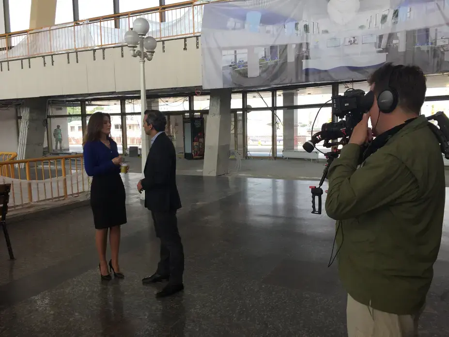 Zach Fannin (behind the camera) and Nick Schifrin interview Yulia Marushevska, the head of Odessa customs