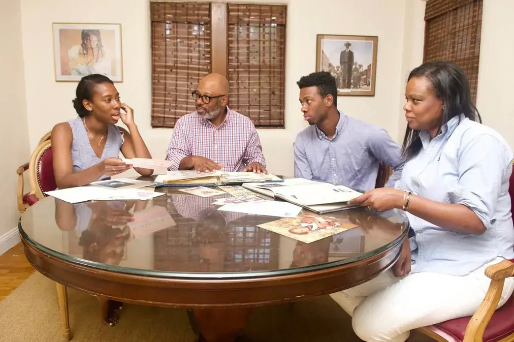 Caroline Washington with her father, Theo, brother Teddy, and mother, Denise as they go through family albums. The family members have been outspoken advocates for education and social justice over many generations. Image by Wiley Price. United States, 2019. Caroline Washington with her father, Theo, brother Teddy, and mother, Denise as they go through family albums. The family members have been outspoken advocates for education and social justice over many generations. Image by Wiley Price. United States, 2019.