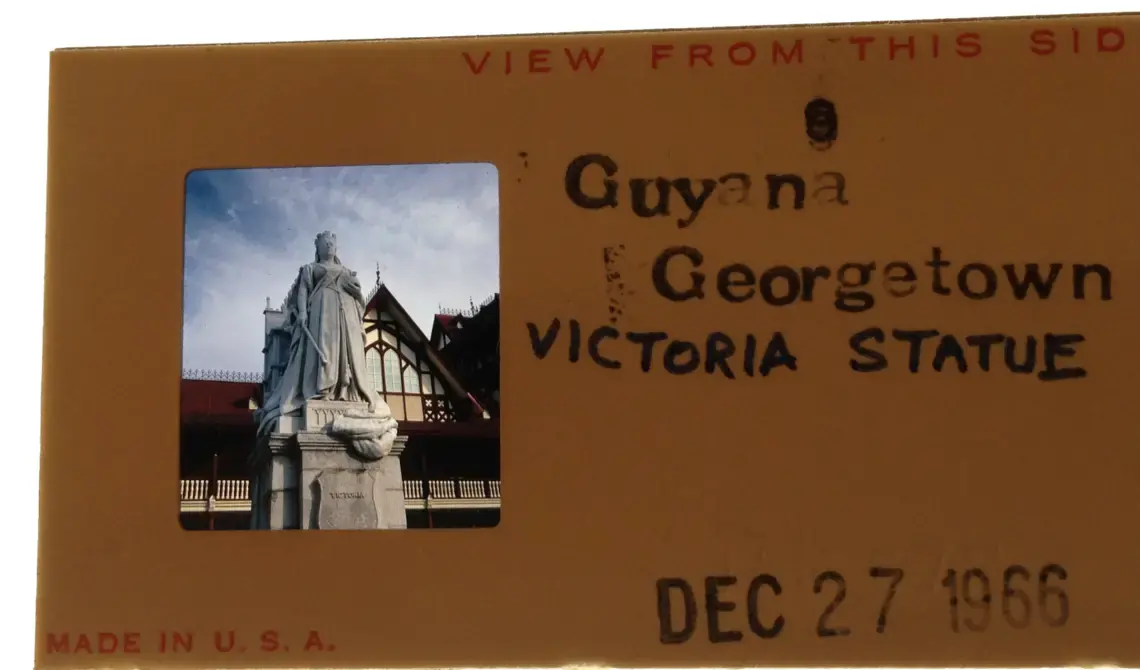 Slide provided by a volunteer to the CIA who traveled to Guyana in 1966, the year of its independence. Pictures a statue of Queen Victoria in front of the Supreme Court. Photo by Chester Burger. Courtesy of the Burger Family. Guyana, 1966. Media file: victoria_statue_3.jpg