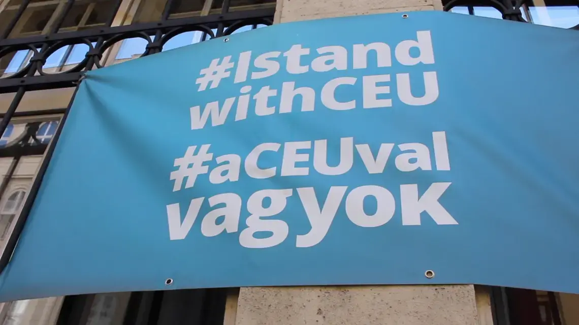 "You cannot exist for a very long time like this," says Zsolt Enyedi of Central European University. Image by Laura Butterbrodt. Hungary, 2019. A banner reads "Hashtag: I Stand With CEU," referencing many students' wish to stay in Budapest.