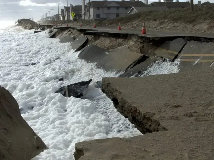 Waves lap at N.C. 12 in Kitty Hawk at low tide Oct. 10, 2016. This section has since been repaired. Image by Kip Tabb. United States, 2016.