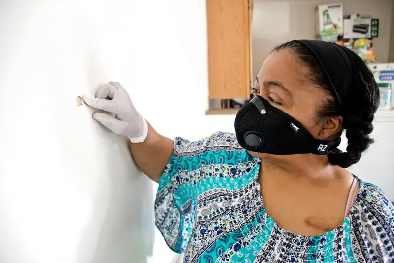 Kim Daniel shows where a bullet fired from a nearby apartment entered her unit. Image by Wiley Price/St. Louis American. United States, 2020. Kim Daniel shows where a bullet fired from a nearby apartment entered her unit. Image by Wiley Price/St. Louis American. United States, 2020.