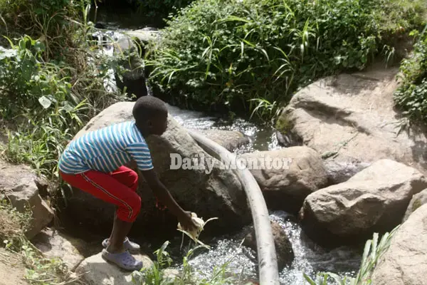 A child dumps waste in river Mpanga in Karangura in Kabarole District, Uganda. Image by Felix Basiime. Uganda, undated.