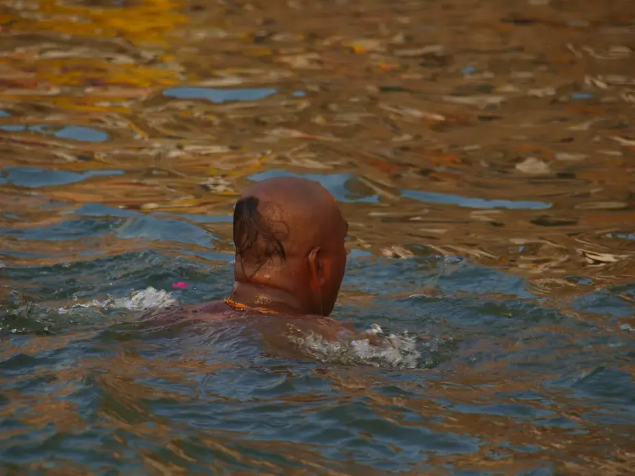 A pilgrim takes a holy dip in river Ganges