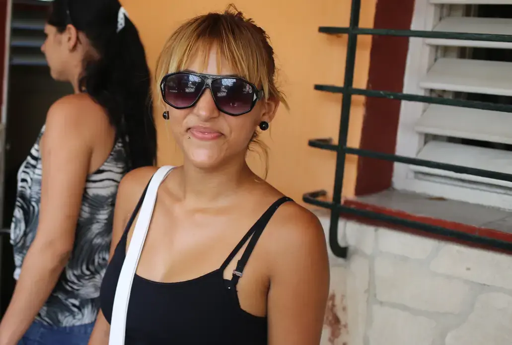 Some 20-somethings spend their free time at the beach at nightclubs. Arelys Blanco, 22, would rather hit the streets and pass out photos of political prisoners.
She’s a member of the Ladies in White, a political opposition group founded 12 years ago to push for the release of 75 democracy activists, journalists and others jailed in a 2003 crackdown.
"I never agreed with this regime, and so I joined," Blanco said. "I want total change for this country." Image by Tracey Eaton. Cuba, 2015. Media file: arelis.jpg