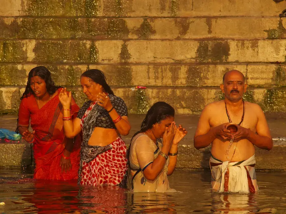 Pilgrims take a “holy dip” in the sacred river. Image by George Black. India, 2015. Pilgrims take a “holy dip” in the sacred river. Image by George Black. India, 2015.