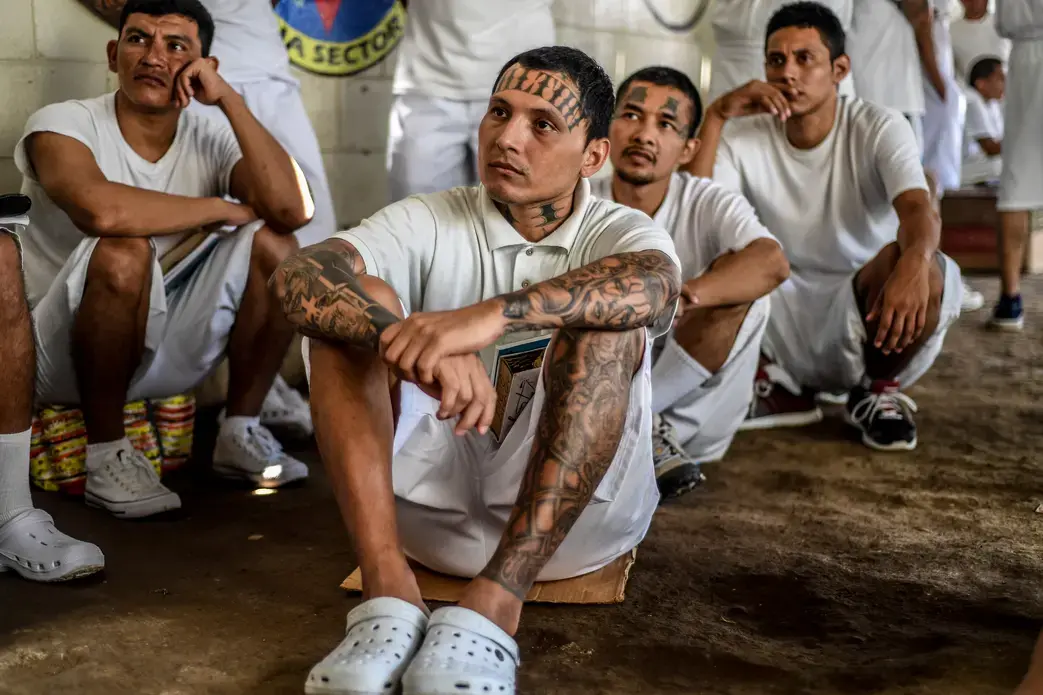 In Apanteos prison, former members of MS-13 who have converted to evangelical Christianity listen to a prison preacher. Image by Danny Gold. El Salvador, 2019.