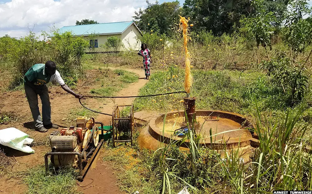 A water pump technician testing an abandoned borehole near a health facility in Lakwana sub-county, Omoro district. Image by Arnest Tumwesige. Uganda, 2020. A water pump technician testing an abandoned borehole near a health facility in Lakwana sub-county, Omoro district. Image by Arnest Tumwesige. Uganda, 2020.