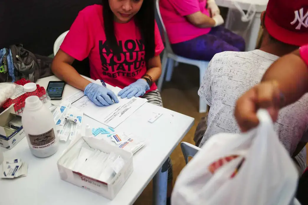 Health officials conduct rapid HIV testing during a fun run in Cebu City. Image by Veejay Villafranca. Philippines, 2015.