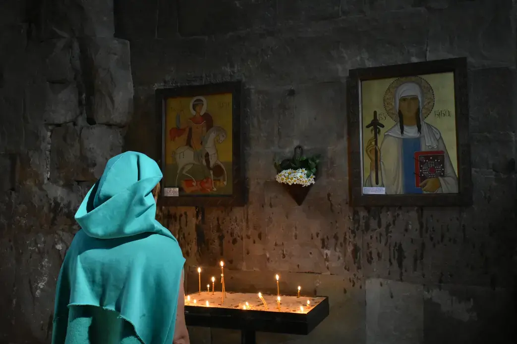 An Orthodox woman prays at the Jvari Monastery. Image by Kaitlyn Johnson. Georgia, 2019. An Orthodox woman prays at the Jvari Monastery. Image by Kaitlyn Johnson. Georgia, 2019.